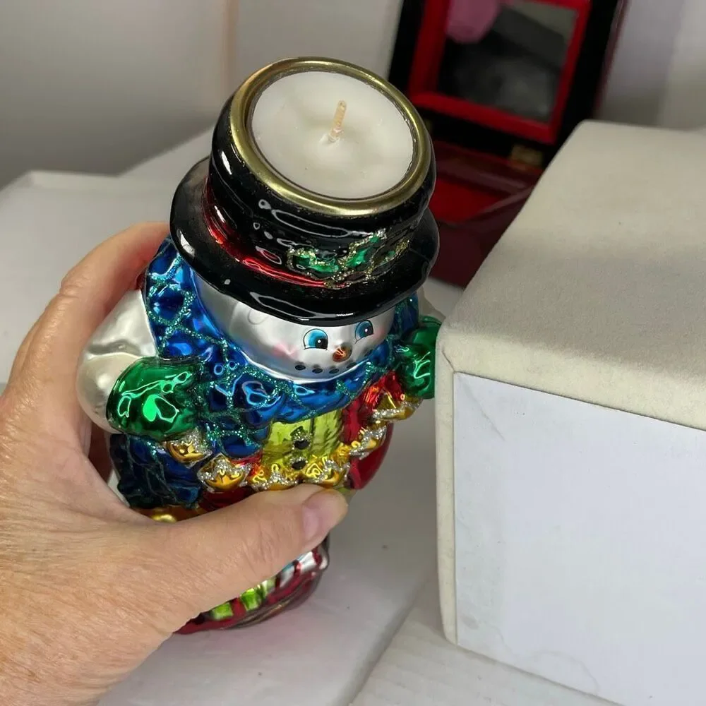 Charming hand-blown mercury glass snowman candle holder.